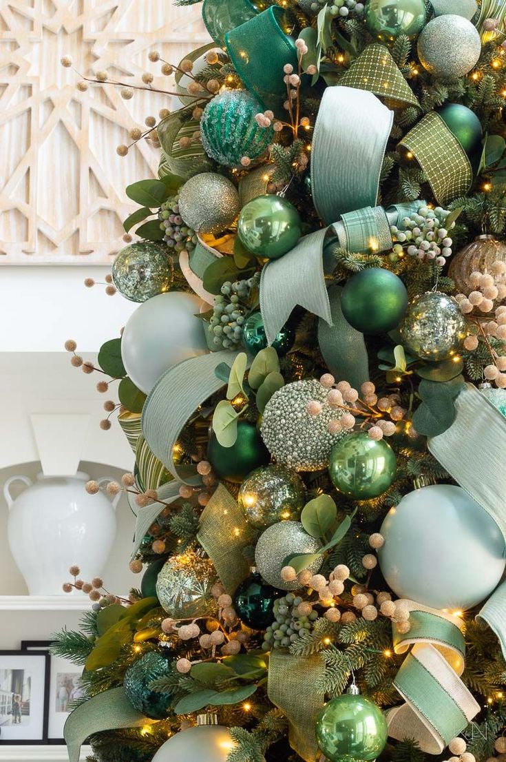 a christmas tree decorated with green and gold ornaments