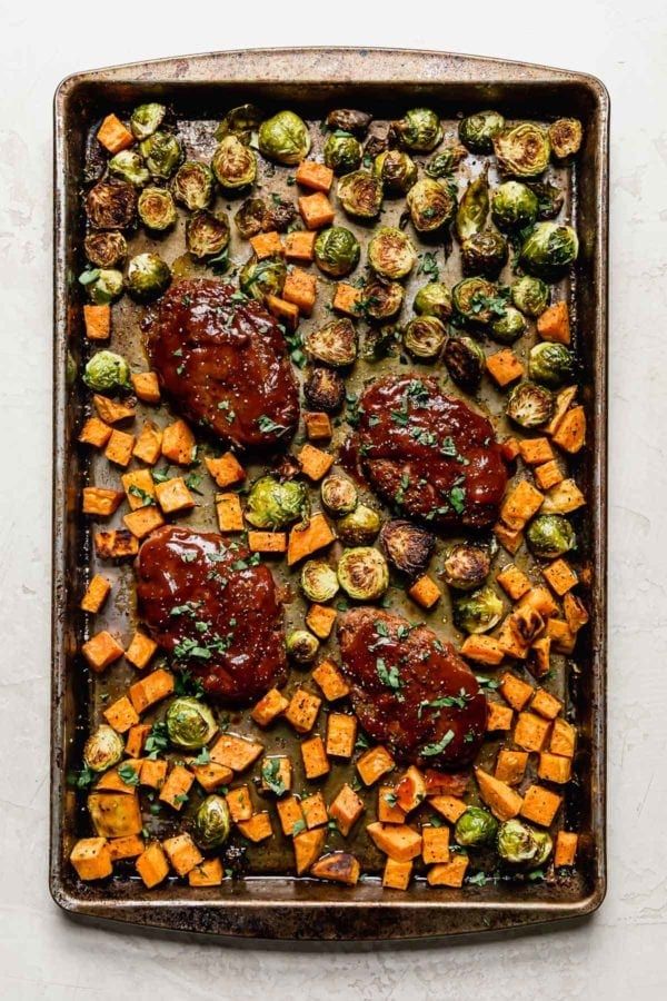 roasted vegetables and meat on a baking sheet