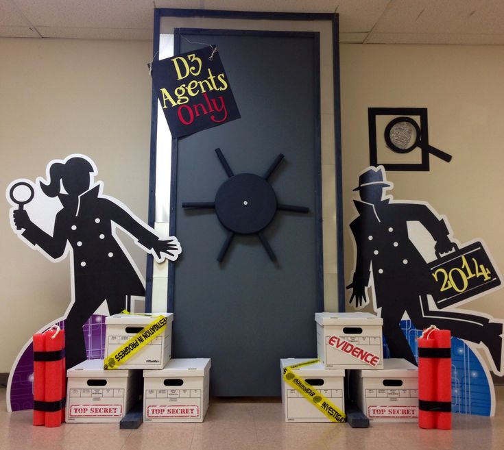 a clock and some cardboard boxes on a table in front of a door that says d3 agent's only