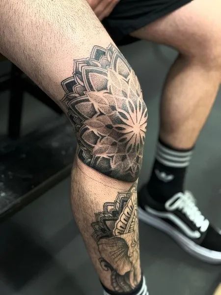 a man's leg with a flower tattoo on it