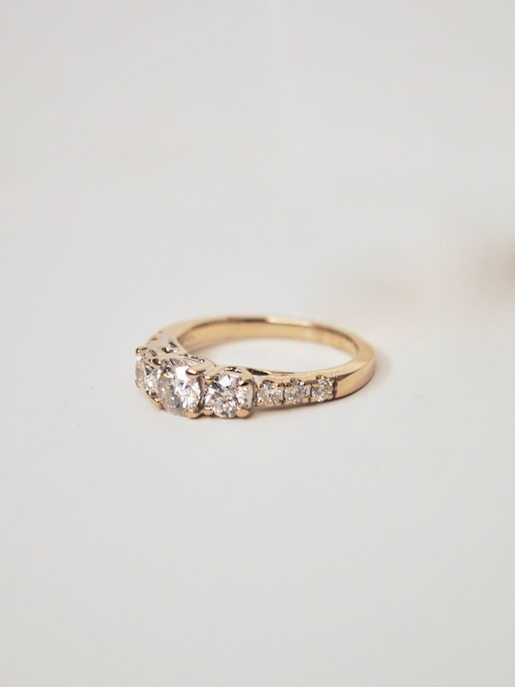 an engagement ring with three diamonds on it