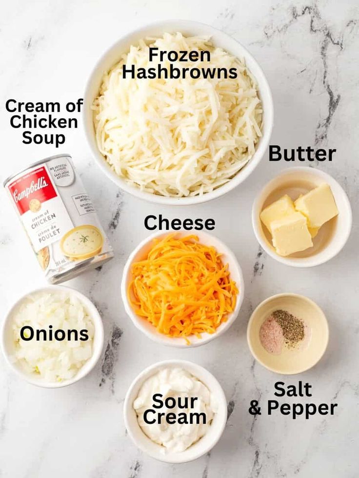 ingredients to make cheese soup laid out in bowls on a white marble counter top with text