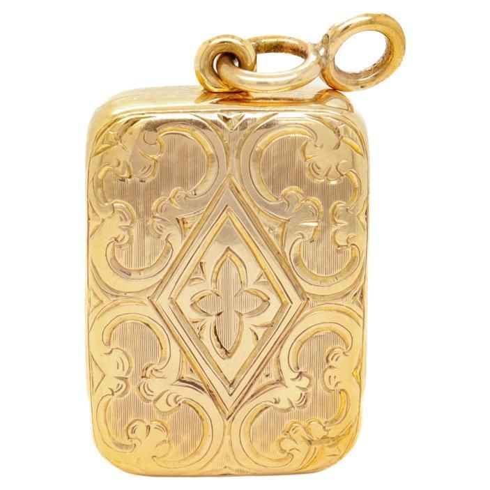 A fine signed Edwardian locket pendant for a necklace. In 14k gold. By Sloan & Co. A small hinged locket style box with etched and engraved decoration to the front, a hinged door that opens to reveal a hidden compartment, and a fixed bail with an attached jump ring. Marked to the interior 14 / Sloan & Co's trident maker's mark. Simply a wonderful Edwardian locket! (Chain for display only and not included.) Date: 20th Century Overall Condition: It is in overall good, as-pictured, used estate cond Elegant Yellow Gold Collectible Locket Necklace, Rectangular Locket Jewelry For Keepsake, Collectible Hallmarked Rectangular Jewelry, Formal Heirloom Locket Necklace Stamped 14k, Elegant Formal 14k Stamped Locket Necklace, Collectible Etched Rectangular Jewelry, Elegant Compact Locket Jewelry, Gold Rectangular Jewelry Keepsake, Luxury Engraved Locket Necklace For Keepsake