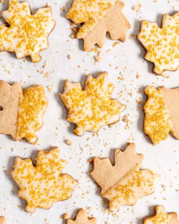 some cookies with frosting and maple leaves on them