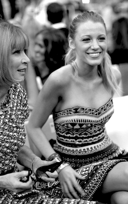 two women sitting next to each other smiling