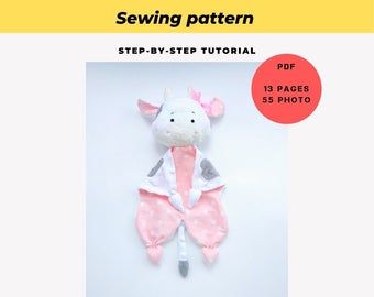 a sewing pattern for a stuffed animal with pink and white clothes on it's back