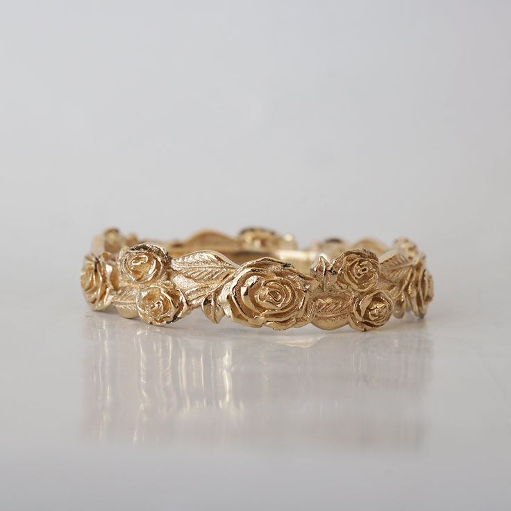 a gold ring with roses on it