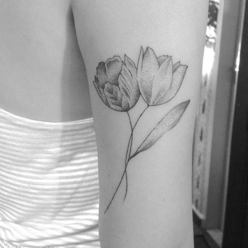 a black and white photo of two flowers on the left side of the right arm