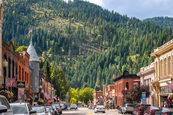 cars driving down a street in the mountains