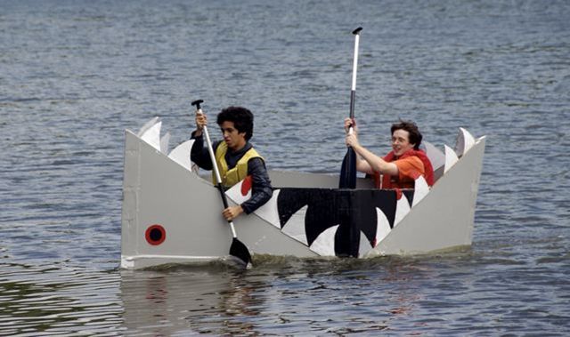 two people on a boat in the water with paddles and oars attached to it