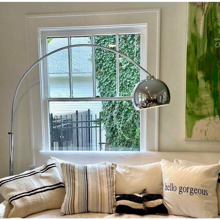 a living room with a white couch and large window