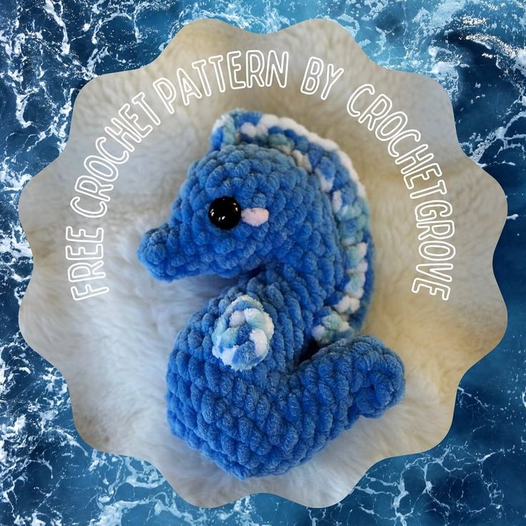 a blue crocheted stuffed animal sitting on top of a white plate with the words free crochet pattern by crocheting above it