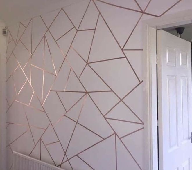 a white wall with gold lines painted on it