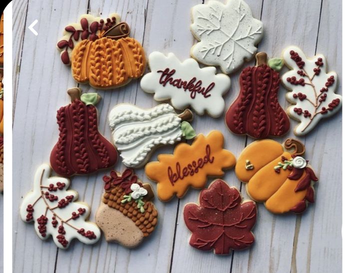 decorated cookies are arranged on a white wooden surface with the words happy thanksgiving written in red