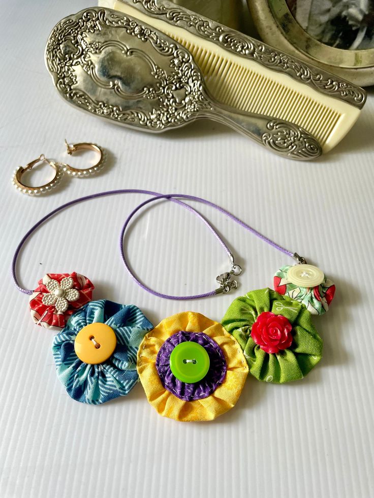 A wonderful accessory choice for summer events, this necklace brings a pop of color to your outfit of the day! Lightweight and easy to wear, this necklace won't leave you feeling weighed down on hot days. Summer Flower Pendant Necklace Gift, Multicolor Flower Necklace For Summer Beach, Bohemian Multicolor Flower Necklace For Summer, Summer Beach Flower Charm Necklace, Yellow Flower Necklace For Summer, Summer Beach Flower Necklace With Charm, Summer Beach Flower Necklace With Flower Charm, Summer Yellow Flower Necklaces, Summer Yellow Flower Necklace