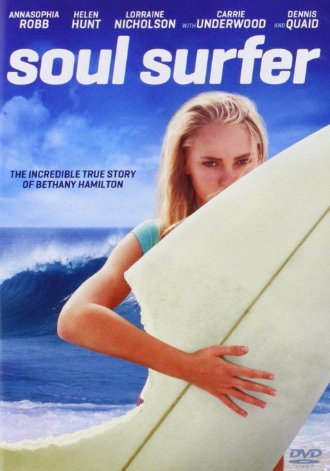 a woman holding a surfboard in front of the ocean with her arms behind her back