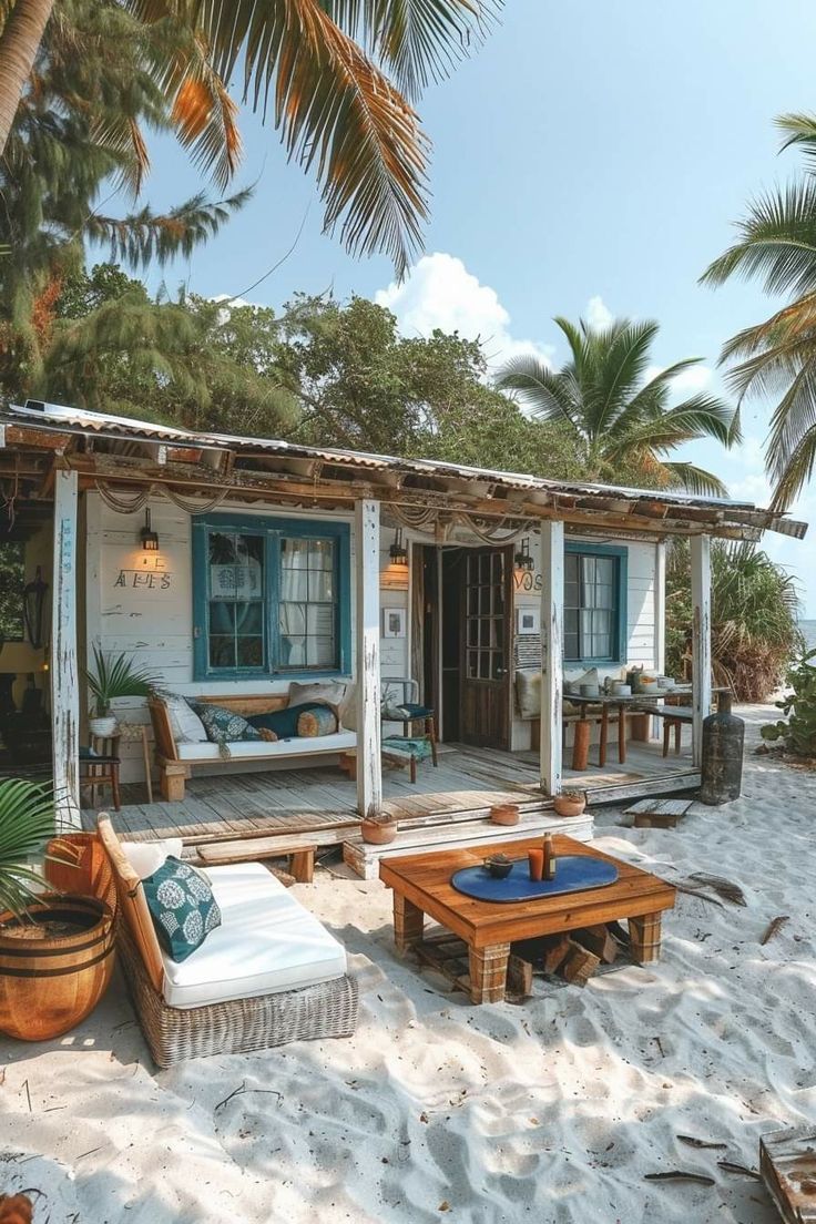 the beach house is surrounded by palm trees and white sand, with blue shutters