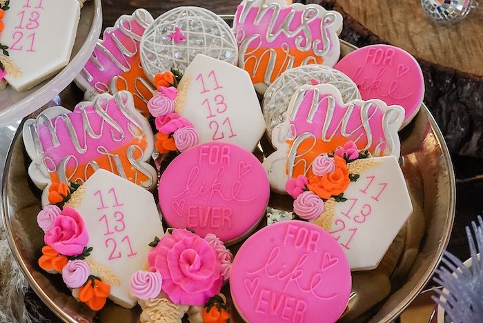 some decorated cookies are in a bowl on the table