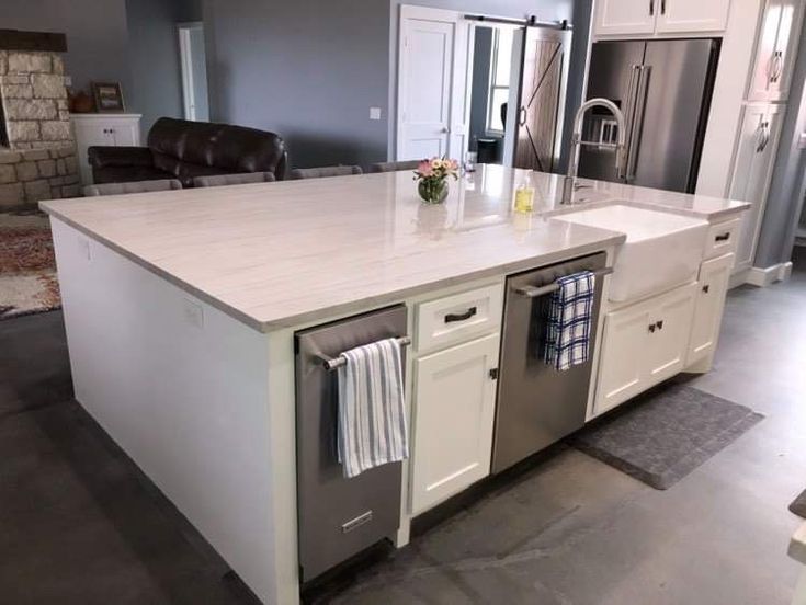 a large kitchen island with an oven and dishwasher