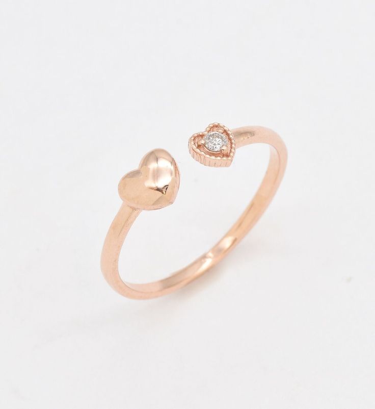 Certified Real Diamond Open Heart Ring set with Diamond, size 2 millimeters diameter, 0.03 Carats.Solid 14k Rose Gold ☞ made to last.Click here for ☞ Solid Gold CollectionDiamond Details:• CERTIFIED Natural Diamond• Weight: 0.03 Carats• Dimensions: 2mmSolid Gold Details:• 1.2 grams of 14k Solid Rose Gold• Dimensions: Band width ≈ 1.5mm, thickness ≈ 1mm• Lasts a lifetime - Perfect for everyday use (won’t tarnish)! *Final weight & dimensions depending on the chosen ring sizeSKU RT-1543 Promise Rose Gold Couple Rings With Open Design, Rose Gold Promise Couple Rings With Open Design, Heart Cut Rose Gold Stackable Promise Rings, Rose Gold Open Couple Rings For Promise, 14k Rose Gold Heart Ring, Rose Gold Heart Cut Stackable Rings For Promise, Heart Shaped Rose Gold Diamond Ring, 14k Rose Gold Heart Ring For Anniversary, Rose Gold Heart Cut 14k Gold Ring