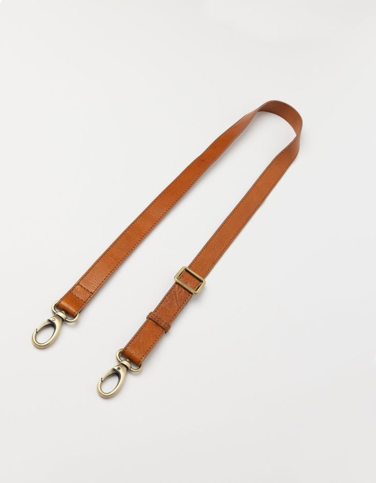 The details on this strap are made from our Stromboli leather which has a slightly textured appearance. Shorter than our regular webbing straps, with a maximum length of 115cm, this strap features our brass dog hooks and can be used on any O My Bag. Our personal favorite is the Beck's Bum Bag x leather strap combo. Minimum length: 67cm and Maximum length: 115cm. OMB-leatherbumbagstrapbs Classic Bag Strap For Everyday Use, Rectangular Leather Bag Strap With Leather Handles, Rectangular Leather Bag Strap With Handles, Classic Leather Bag Strap For Travel, Classic Adjustable Bag Strap For Everyday Use, Gold Bag Strap For Everyday Use With Long Strap, Classic Everyday Adjustable Bag Strap, Leather Travel Bag Strap With Leather Handles, Leather Bag Strap With Leather Handles For Everyday