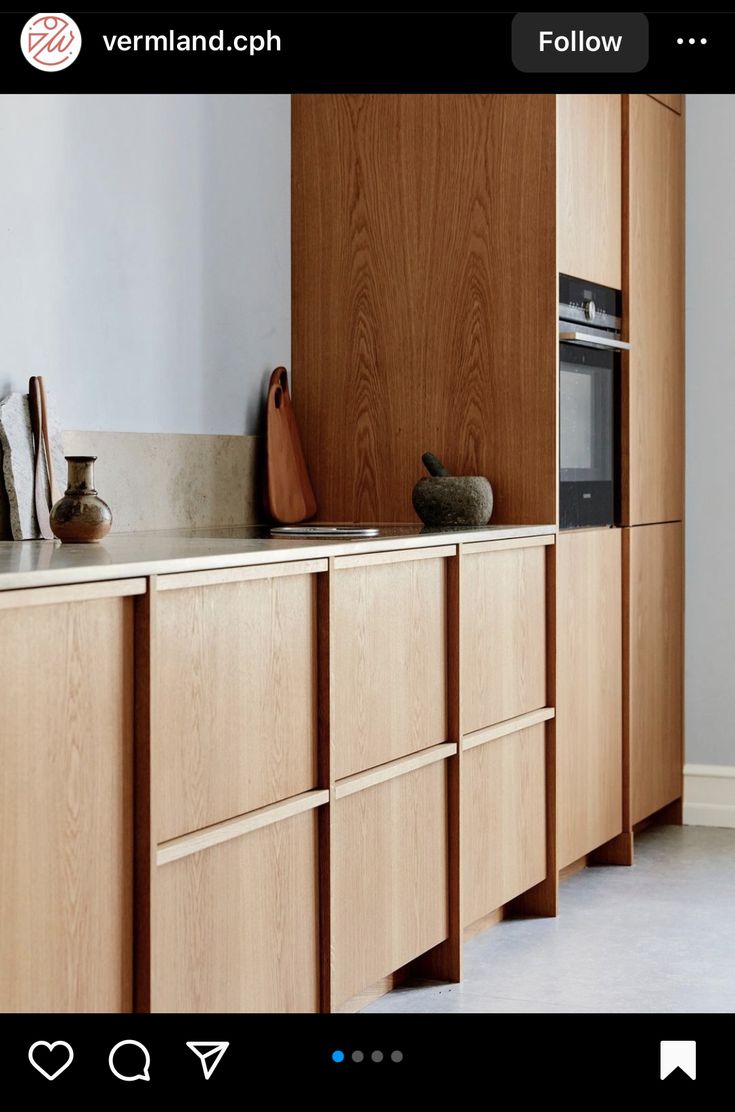 a kitchen with wooden cabinets and white walls