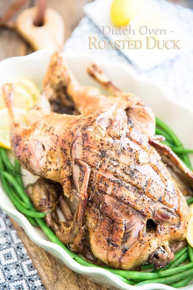 roasted chicken with lemons and green beans in a white bowl