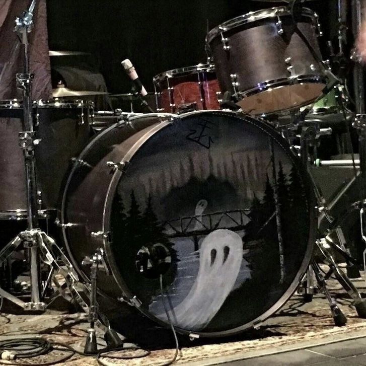 a drum kit with a ghost painted on it