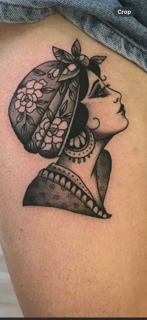 a woman's thigh with a tattoo design on the back of her leg and head