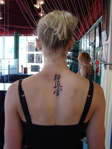 a woman with a tattoo on her back