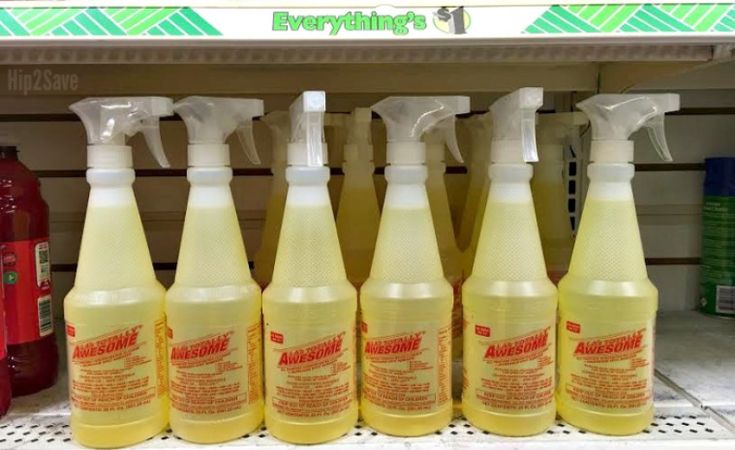 several bottles of cleaner are lined up on the shelf