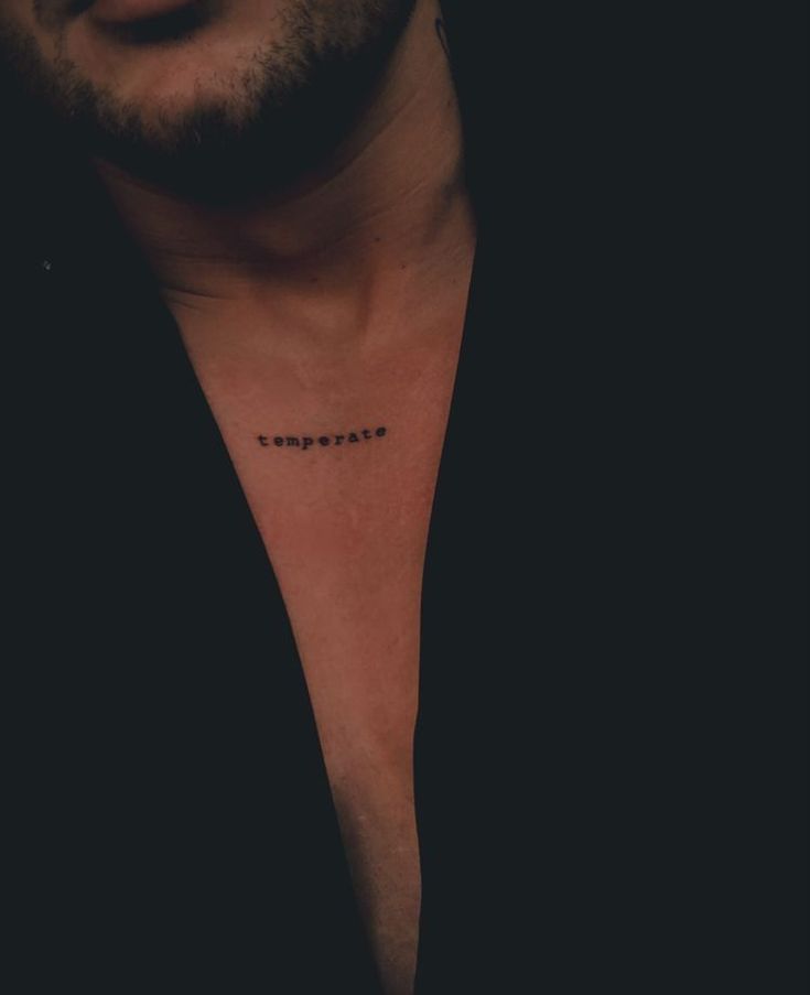 a man's chest with the word love written on it in cursive font