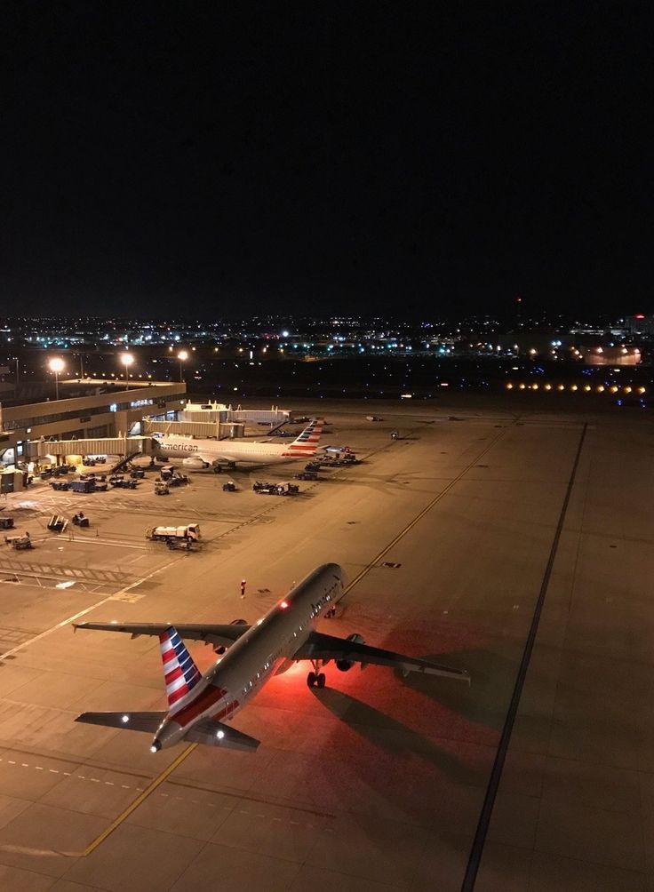 an airplane is parked on the runway at night