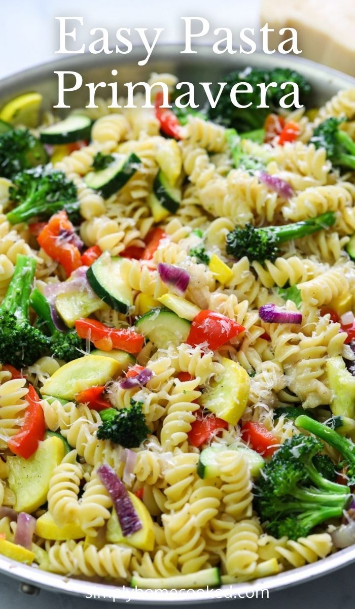 a pasta dish with broccoli, zucchini and red peppers in it