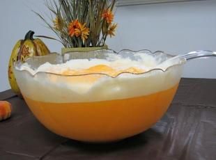 an orange and white liquid in a glass bowl