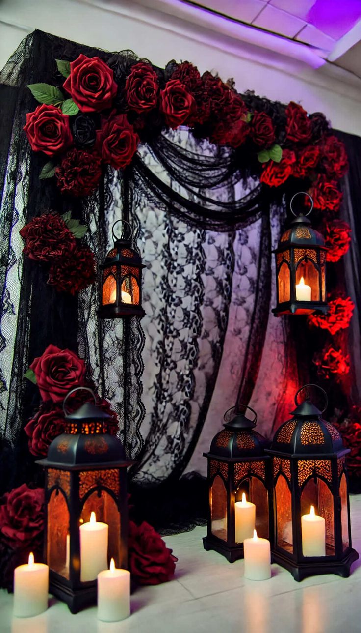 several lit candles are sitting in front of a backdrop with red roses and black lace