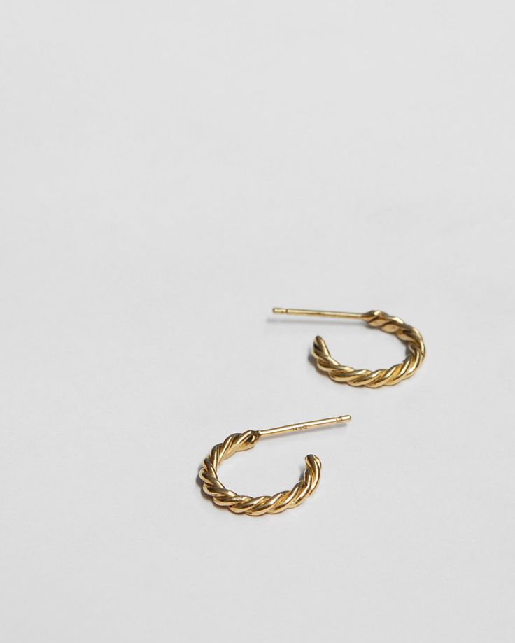 These delicate and perfect everyday hoops are twisted by hand with two strands of soft wax and then cast into recycled gold. Hoops measure 5/8" in diameter, available in 10k or 14k yellow gold, with 14k posts and backs. Availability: Made to order, ships in 2-4 weeks. Need it sooner? Please don't hesitate to get in touch and we'll do our best to accommodate. Everyday 14k Gold Earrings With A Modern Twist, Minimalist Twisted Yellow Gold Jewelry, Delicate 14k Yellow Gold Hoop Earrings, Minimalist Twisted Gold Jewelry, Modern Twist Small Hoop Yellow Gold Jewelry, Everyday Twisted Yellow Gold Jewelry, Twisted Yellow Gold Jewelry For Everyday, Tiny 14k Gold Filled Yellow Gold Hoop Earrings, Twisted 14k Gold Hoop Earrings