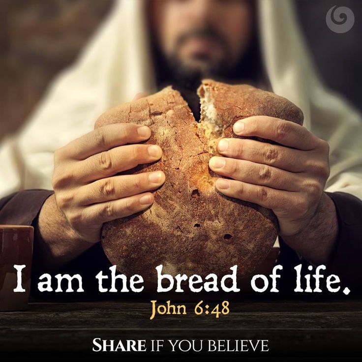 a man holding a piece of bread with the words i am the bread of life