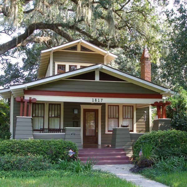 a small house with trees and bushes around it