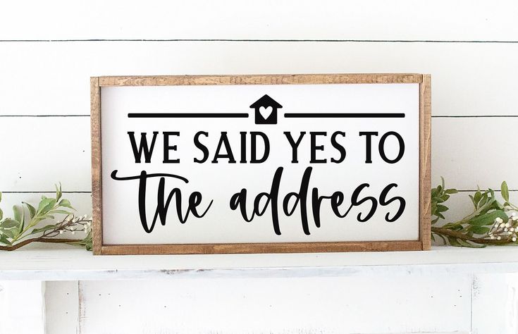 a sign that says we said yes to the address is on top of a shelf