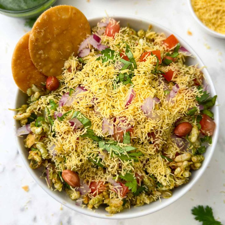 a white bowl filled with rice and vegetables