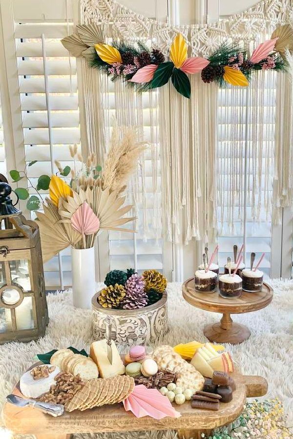 a table topped with lots of food on top of a white rug next to a window