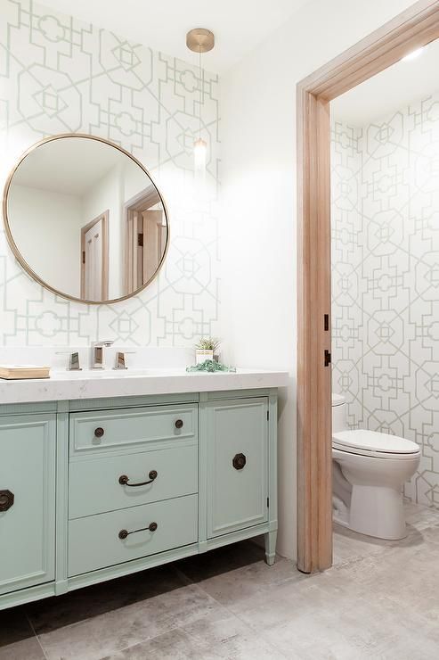 a bathroom with a sink, toilet and mirror