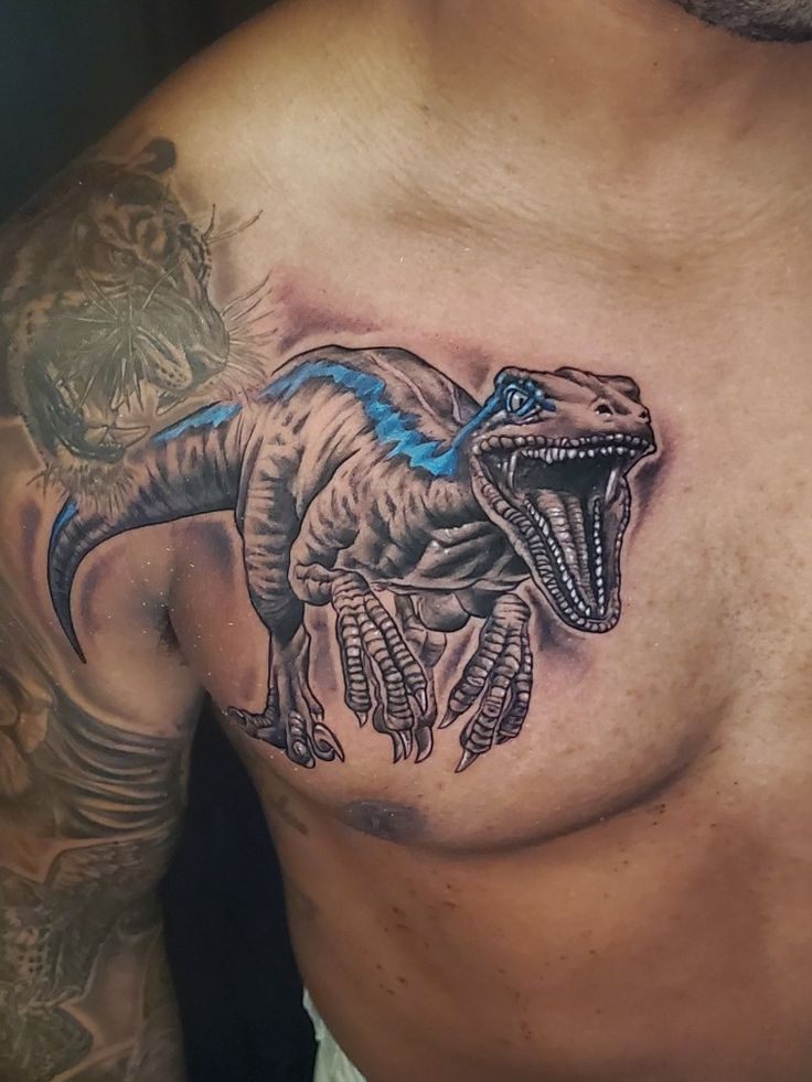 a man with a dinosaur tattoo on his chest