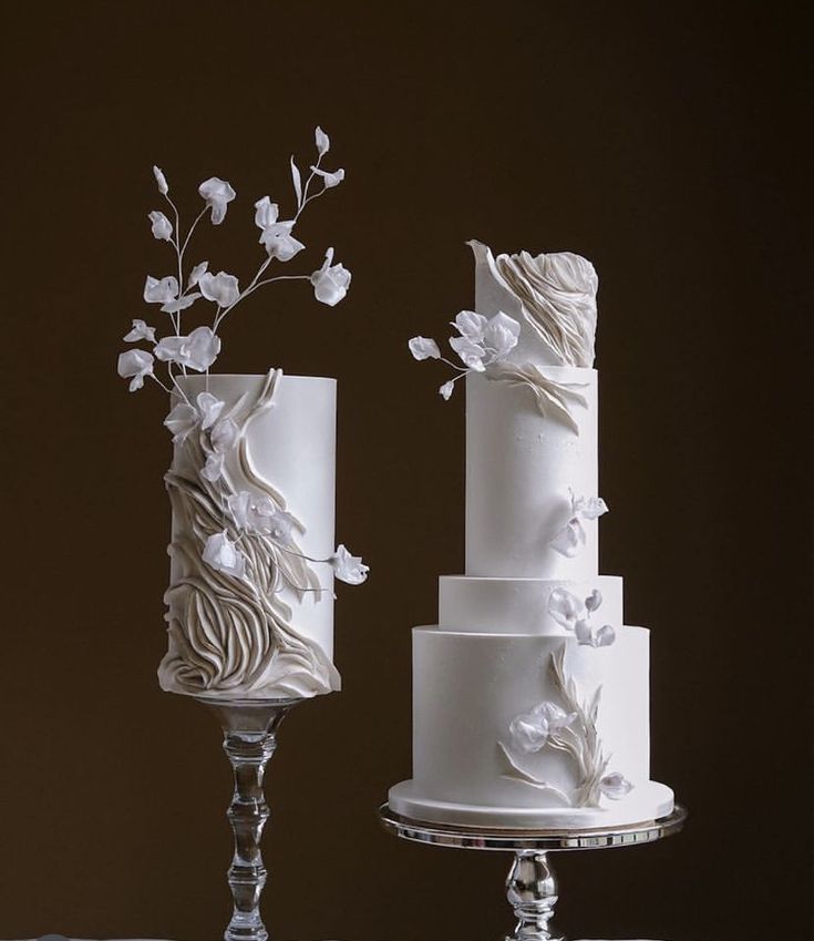 three tiered wedding cakes with white flowers on them