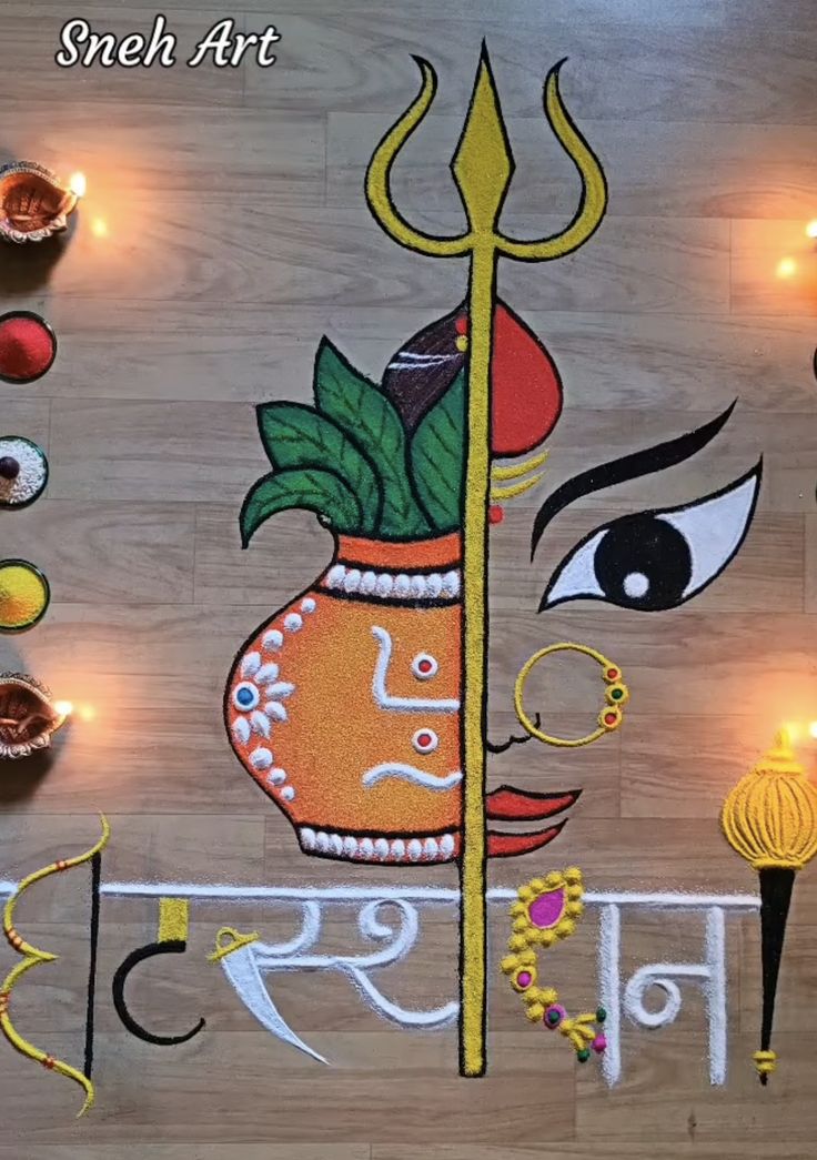 an artistic painting on the floor with candles and lights in the background for diwaling