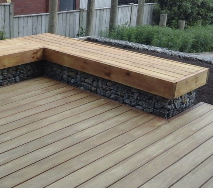 a wooden bench sitting on top of a wooden deck