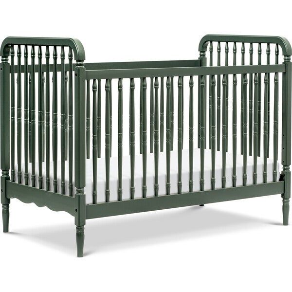 a green crib with white sheets on the bottom and side rails, against a white background