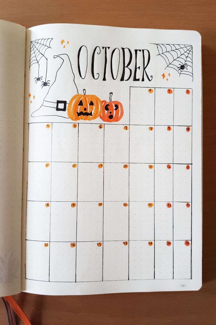 an open planner with pumpkins on it and the words october written in black ink