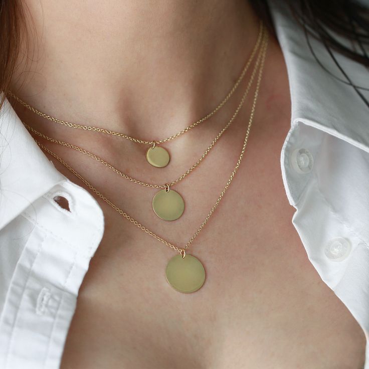 The Chiara necklace is a light gold round disc necklace that you just NEED. Wheather you wear it alone or stacked, with your another necklace or bare alone- it's perfect. Add a personal touch to your Chiara necklace with an engraved portrait of a loved one on one side and their name engraved on the opposite side. If you can dream it- we can make it happen. All features can be customized! Talk to us, we love making custom designs. Our jewelry is carefully handmade in our atelier To order by phone Sterling Silver Necklaces For Layering, Sterling Silver Round Necklaces For Layering, Yellow Gold Charm Necklace With Round Pendant For Layering, Yellow Gold Round Pendant Charm Necklaces For Layering, Yellow Gold Round Pendant Necklace For Layering, Minimalist Jewelry With Coin Pendant, Everyday Yellow Gold Medallion Necklace, Minimalist Round Clavicle Chain Charm Necklace, 14k Gold Coin Pendant Chain Necklace